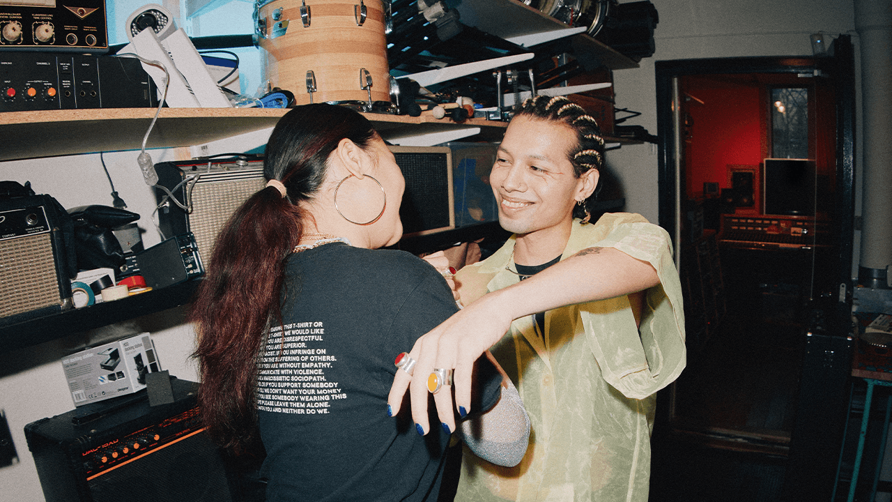 Two people smiling and greeting each other