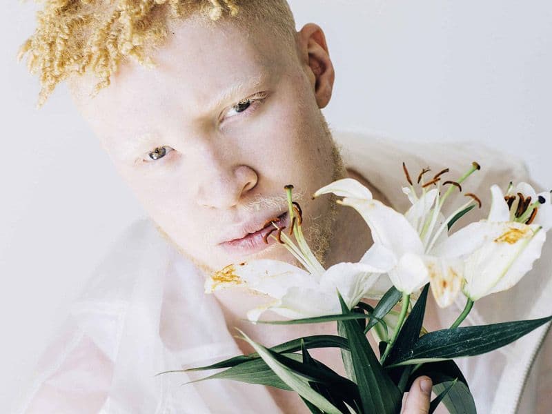 Model Shaun Ross holding flowers