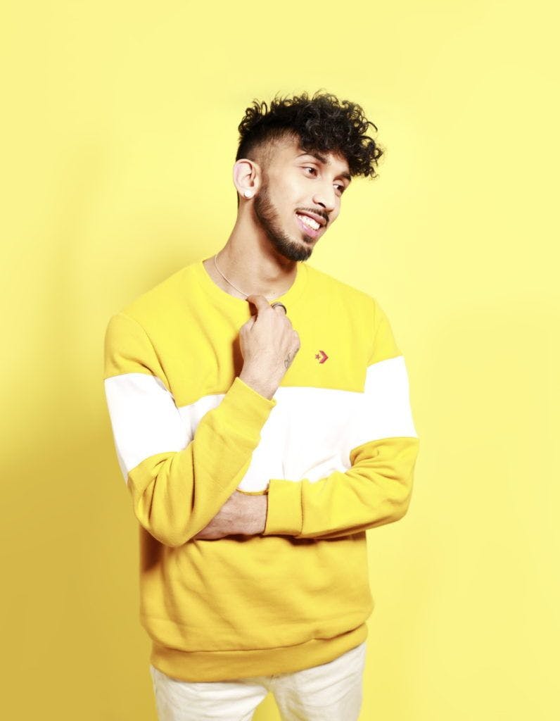 A man wearing a yellow shirt with a yellow background
