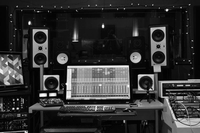 A recording studio with speakers and mixing equipment